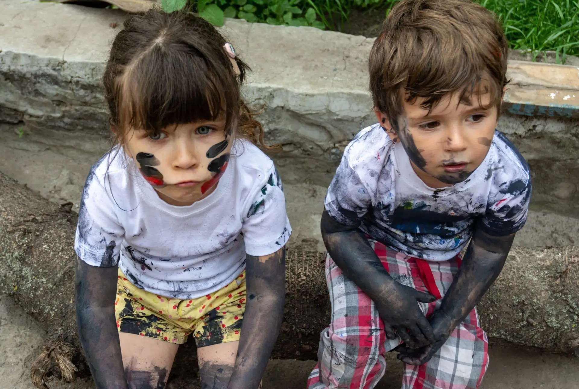 two children with black paint on their faces
