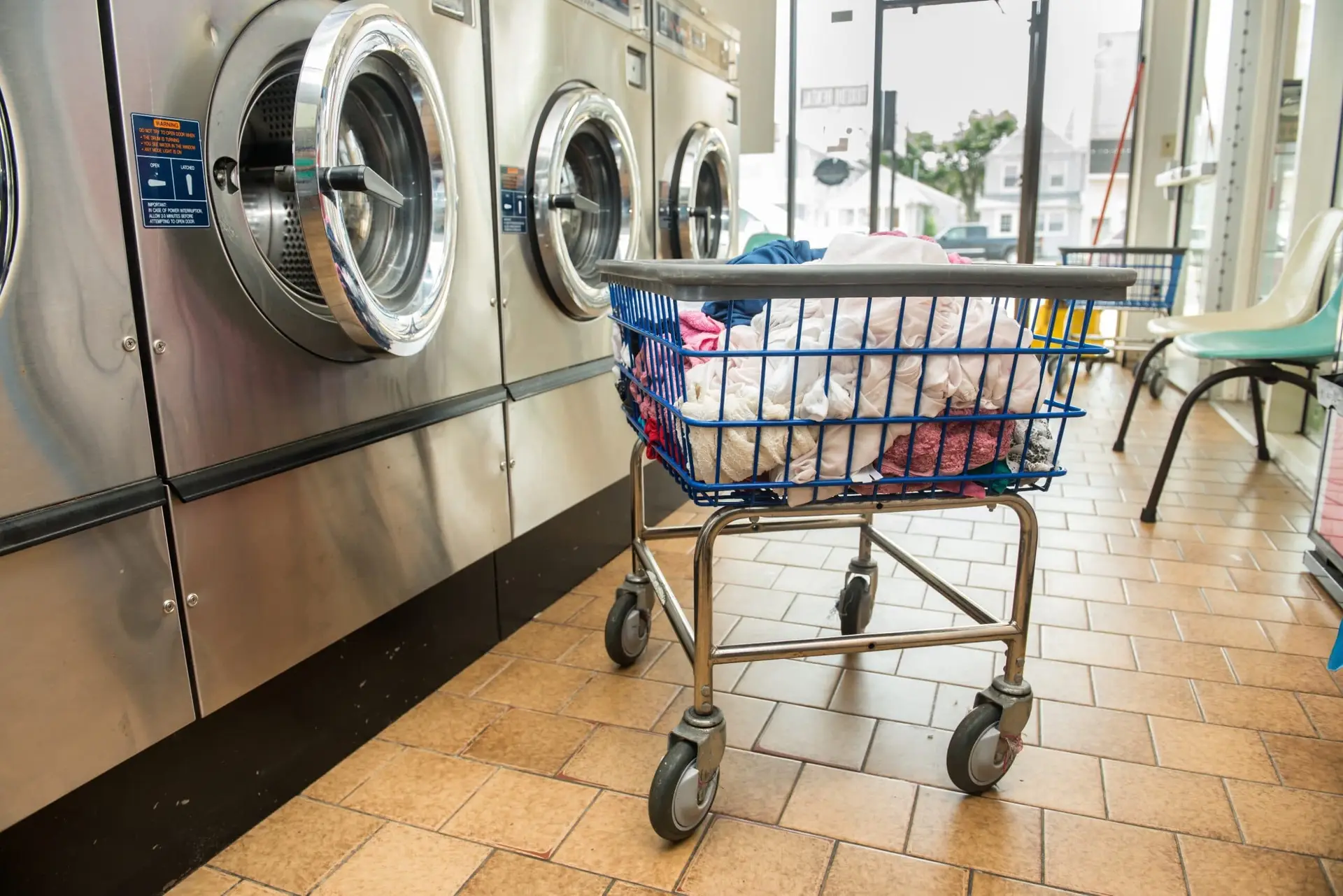 a laundry cart in front of a washing machine
