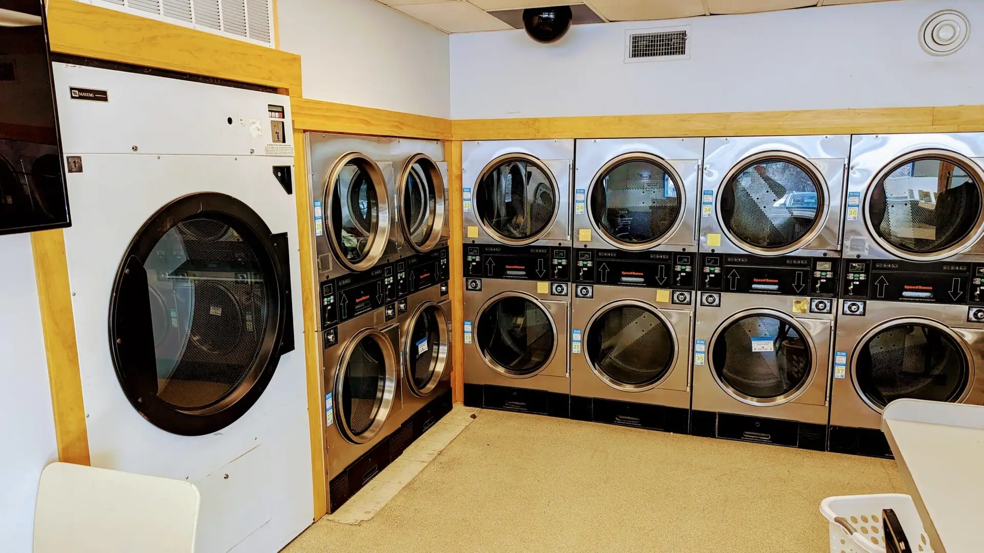 a group of washing machines in a laundry room