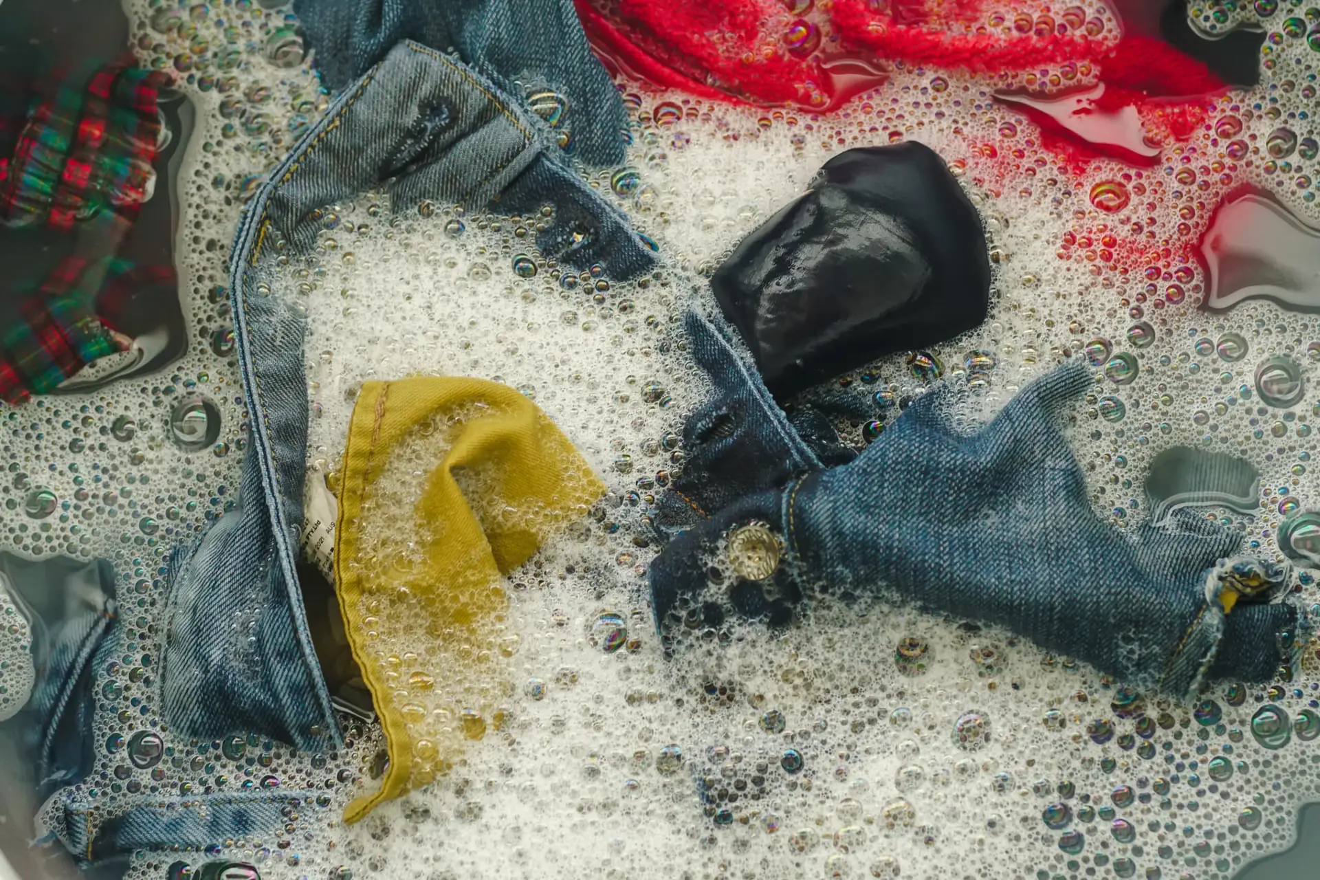clothes in a basin of soapy water