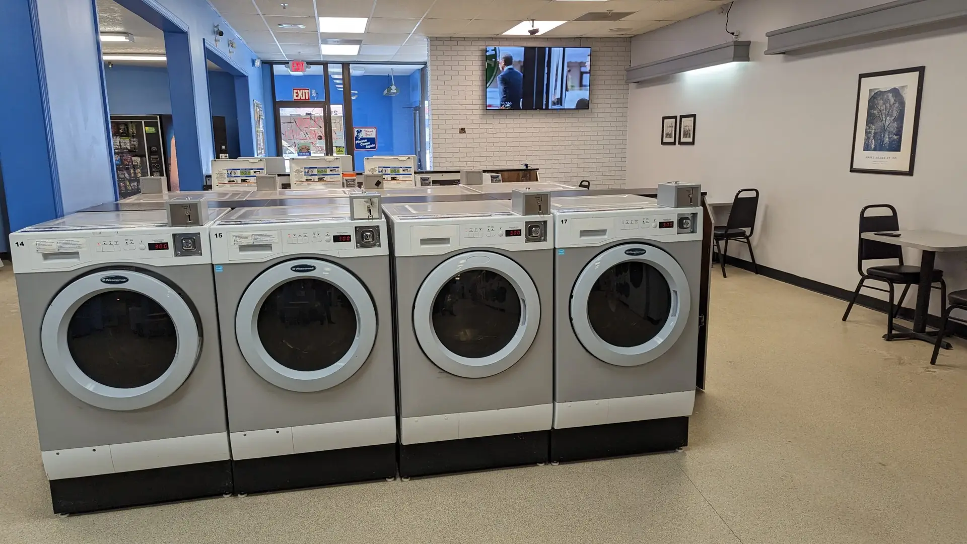 a row of washing machines in a laundry room