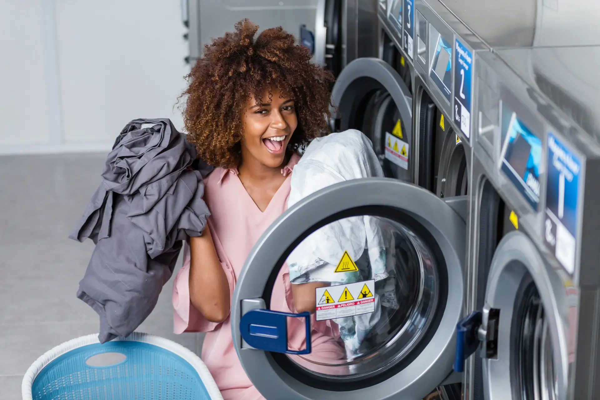 a woman holding a clothes in a dryer